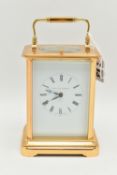 A BRASS 'MATTHEW NORMAN' CARRIAGE CLOCK, with repeat mechanism, white enamel dial, black Roman