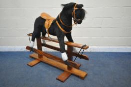 A PEGASUS OF CREWE CHILDS BLACK AND WHITE ROCKING HORSE, with tanned leather saddle and accessories,