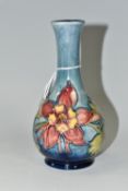 A MOORCROFT POTTERY 'COLUMBINE' PATTERN BUD VASE, yellow and pink flowers on a blue ground,