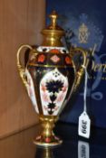 A BOXED ROYAL CROWN DERBY TWIN HANDLED URN, complete with cover, 1128 pattern, approximate height