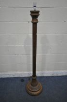 A 20TH CENTURY OAK STANDARD LAMP, with turned and carved pillar support, on a domed and stepped