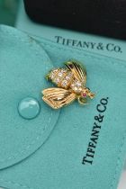 TIFFANY & CO. DIAMOND AND RUBY BEE BROOCH, the body claw set with brilliant cut diamonds, to the
