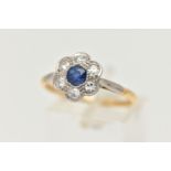 A YELLOW METAL SAPPHIRE AND DIAMOND CLUSTER RING, flower cluster set with a central deep blue,