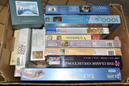 A BOX OF JIGSAW PUZZLES, to include fourteen 1000 and 500 piece jigsaws - of which thirteen are
