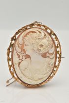 A YELLOW METAL CAMEO BROOCH, of an oval form, carved shell cameo depicting a lady in profile, collet