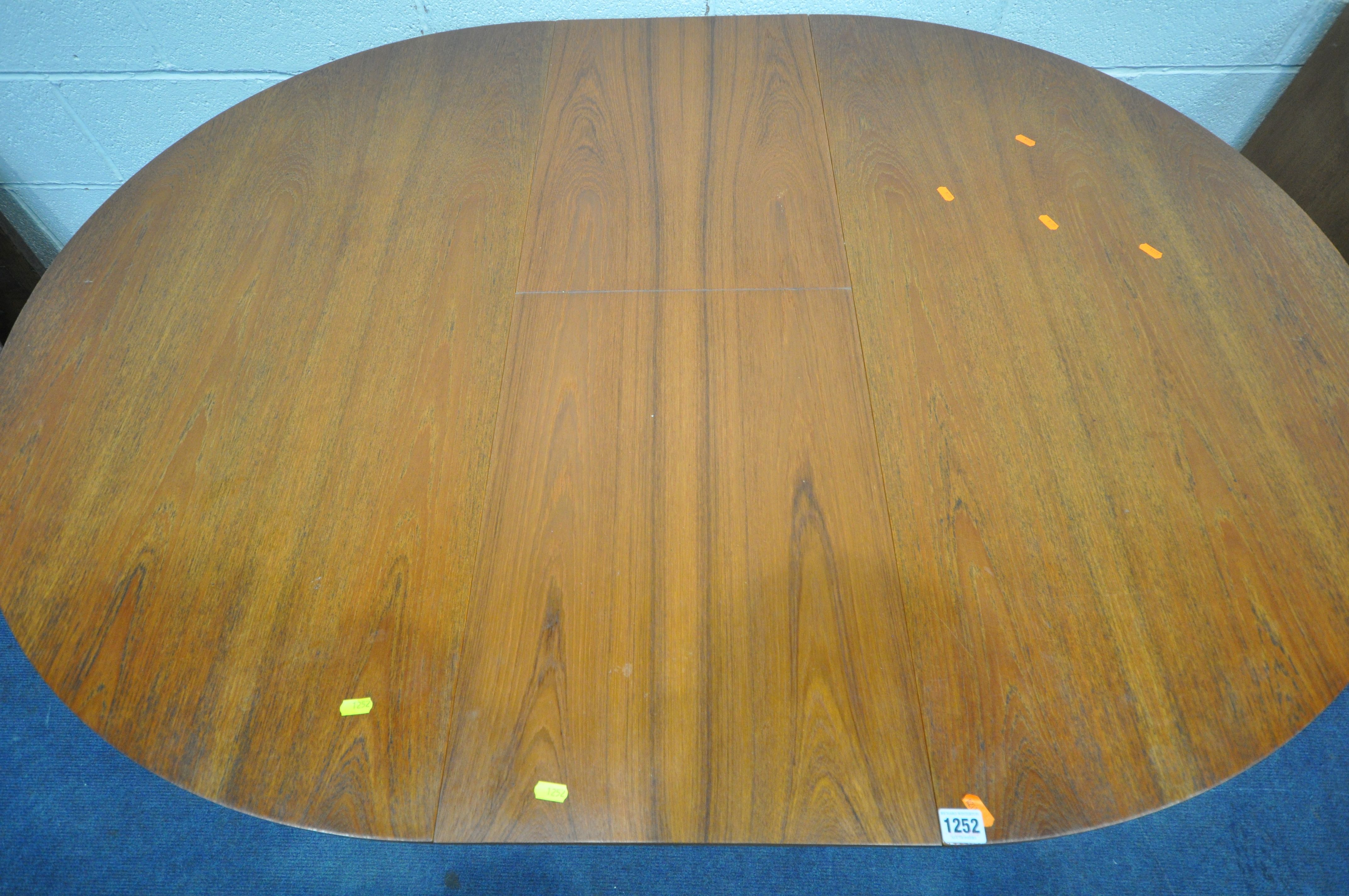 A MID CENTURY TEAK EXTENDING DINING TABLE, with a single fold out leaf, on cylindrical tapered legs, - Image 2 of 4