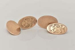 A PAIR OF YELLOW METAL CUFFLINKS, oval cufflinks engraved with a double headed phoenix inscribed '