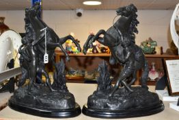 A PAIR OF SPELTER MARLY HORSES, painted black, surmounting a wooden plinth, indistinct signature