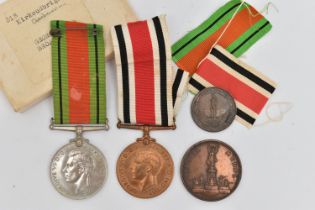 A GROUP OF MEDALS, to include a 1939-1945 Defence medal, with ribbon, unassigned, a WWII