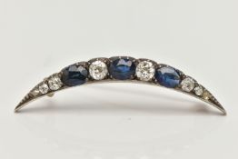 A LATE VICTORIAN DIAMOND AND SAPPHIRE CRESCENT BROOCH, set with three oval cut blue sapphires,