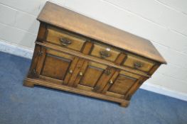 IN THE MANNER OF TITCHMARSH AND GOODWIN, A SOLID OAK SIDEBOARD, with three drawers over three