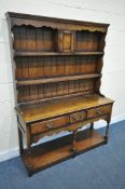 IN THE MANNER OF TITCHMARSH AND GOODWIN, A SOLID OAK DRESSER, the top fitted with an arrangement