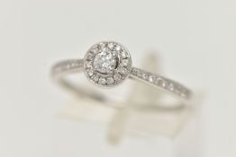 A DIAMOND HALO RING, a single round brilliant cut diamond in a four prong white gold setting,