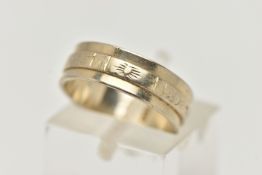 A WHITE METAL WIDE BAND RING, decorated with an engraved central band, approximate band width 5.7mm,