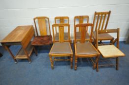 A 20TH CENTURY OAK DROP LEAF TROLLEY, a set of four oak dining chairs, with brown leather drop in