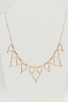 A BI-COLOUR FRINGE NECKLACE, the faceted and tubular design chain suspending triangular fringe drops