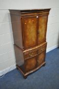 A REPRODUX FLAME MAHOGANY SERPENTINE COCKTAIL CABINET, fitted with four cupboard doors, a brushing