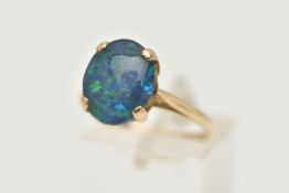 A 9CT GOLD OPAL TRIPLET RING, the oval opal triplet in a four claw setting to the plain band, 9ct