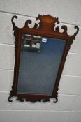 A GEORGIAN STYLE MAHOGANY AND SHELL INLAID FRETWORK WALL MIRROR, with bevelled plate, width 50cm x