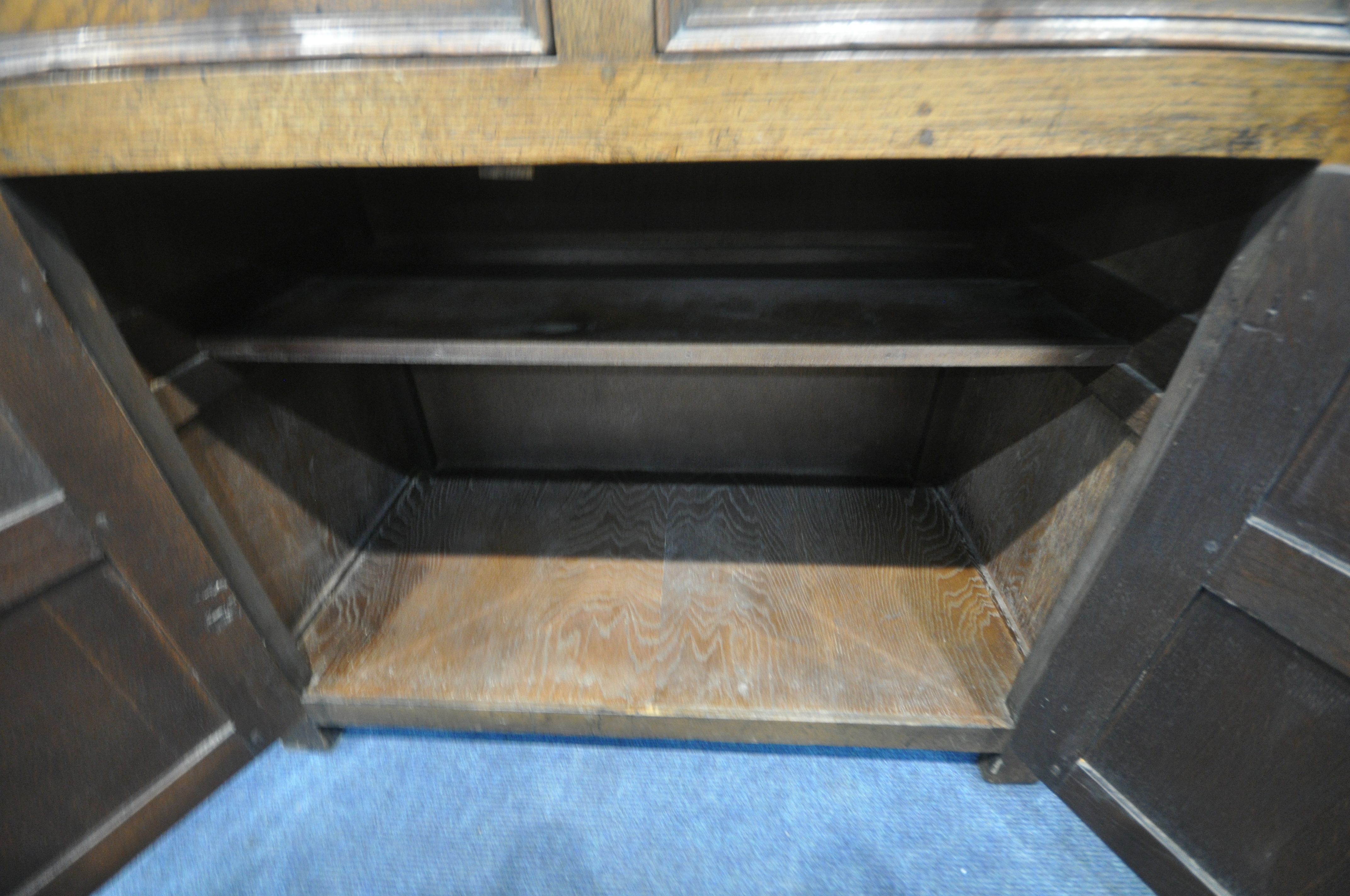 A 20TH CENTURY SOLID OAK CABINET, fitted with two cupboard doors, carved with an archway, a brushing - Image 5 of 6