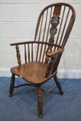 A 19TH CENTURY OAK AND BEECH WINDSOR ARMCHAIR, with a hooped and spindle back rest, a central