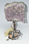 AN AMETHYST CRYSTAL CLUSTER GEODE, supported by a metal display stand with original Harrod's store