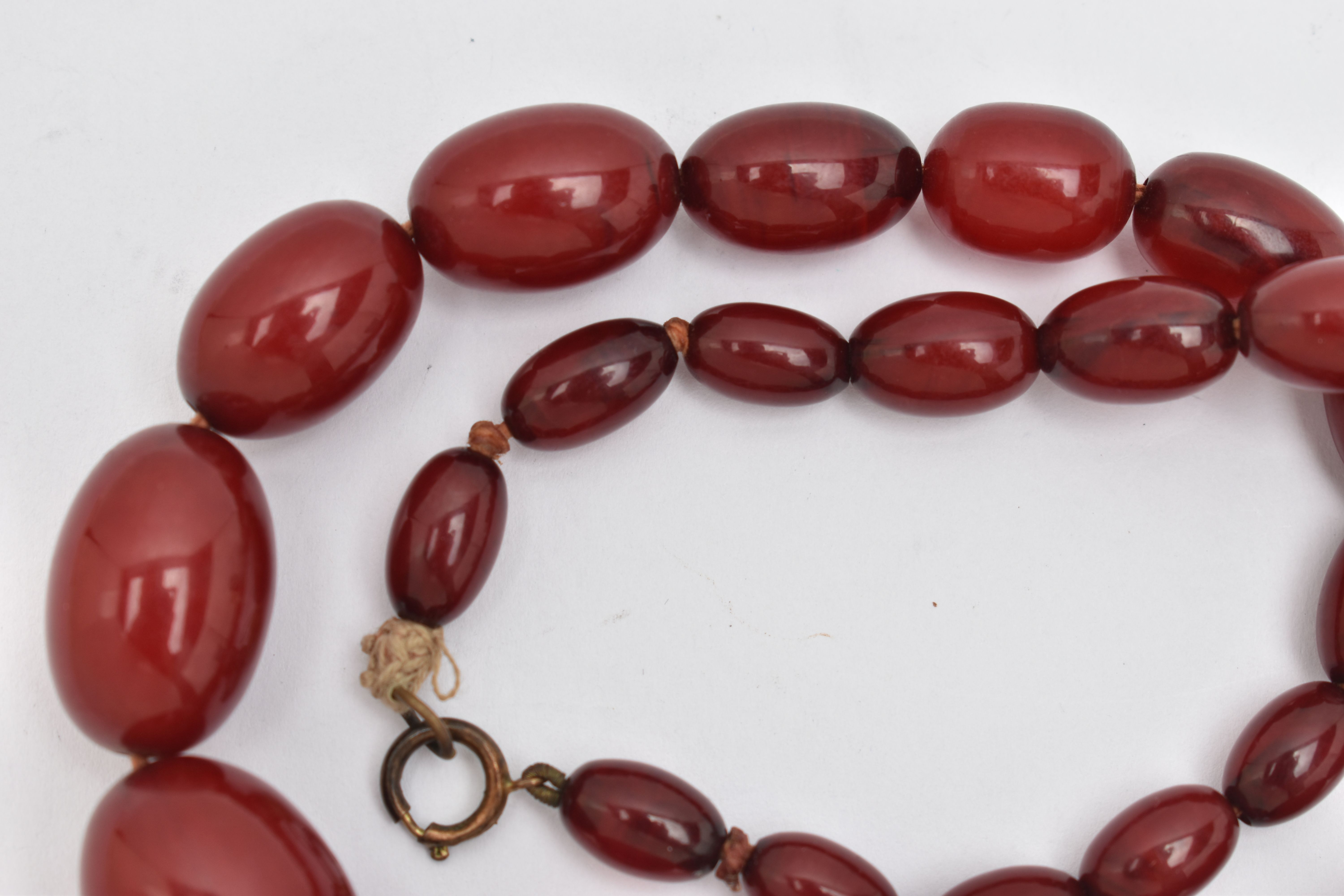 A BAKELITE BEADED NECKLACE, graduated oval cherry amber beads, twenty seven beads in total, - Image 4 of 4