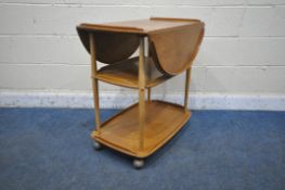 AN ERCOL ELM AND BEECH THREE TIER DROP LEAF TEA TROLLEY, open width 96cm x closed with 48cm x