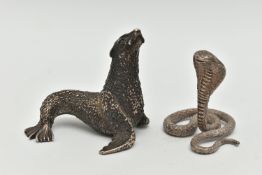 TWO WHITE METAL FIGURINES, the first a textured white metal seal, approximate height 55mm, stamps