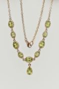 A YELLOW METAL PERIDOT NECKLACE, designed as a row of nine oval cut peridots, each in a claw