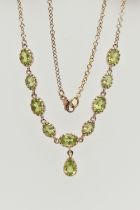 A YELLOW METAL PERIDOT NECKLACE, designed as a row of nine oval cut peridots, each in a claw