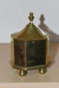 A BRASS TOBACCO JAR, with cover, the jar of octagonal form supported on four feet, height to top