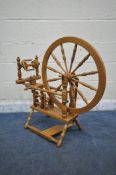 A 20TH CENTURY OAK TIMBERTOPS SPINNING WHEEL, with turned supports and spokes (condition report: