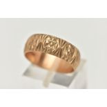 A 9CT YELLOW GOLD RING, designed as a textured band, measuring approximately 7.0mm wide,