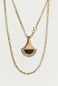 A 9CT YELLOW GOLD DIAMOND AND ONXY PENDANT WITH CHAIN, the abstract design pendant set with an