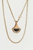 A 9CT YELLOW GOLD DIAMOND AND ONXY PENDANT WITH CHAIN, the abstract design pendant set with an