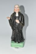 AN EARLY 19TH CENTURY STAFFORDSHIRE PEARLWARE FIGURE OF REV. JOHN WESLEY STANDING WITH ONE ARM