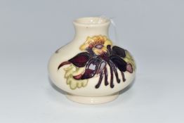 A MOORCROFT POTTERY SQUAT COLUMBINE VASE, tube lined with purple, red and yellow columbine flowers