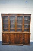 A REPRODUX FLAME MAHOGANY BREAKFRONT BOOKCASE, with four astragal glazed doors, enclosing a