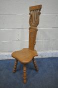 COLIN ' BEAVERMAN' ALMACK, AN ENGLISH OAK SPINNING CHAIR, with leaf scroll carved crest, above a