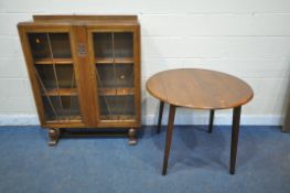 A 20TH CENTURY OAK BOOKCASE, with double glazed doors, enclosing two adjustable shelves, on