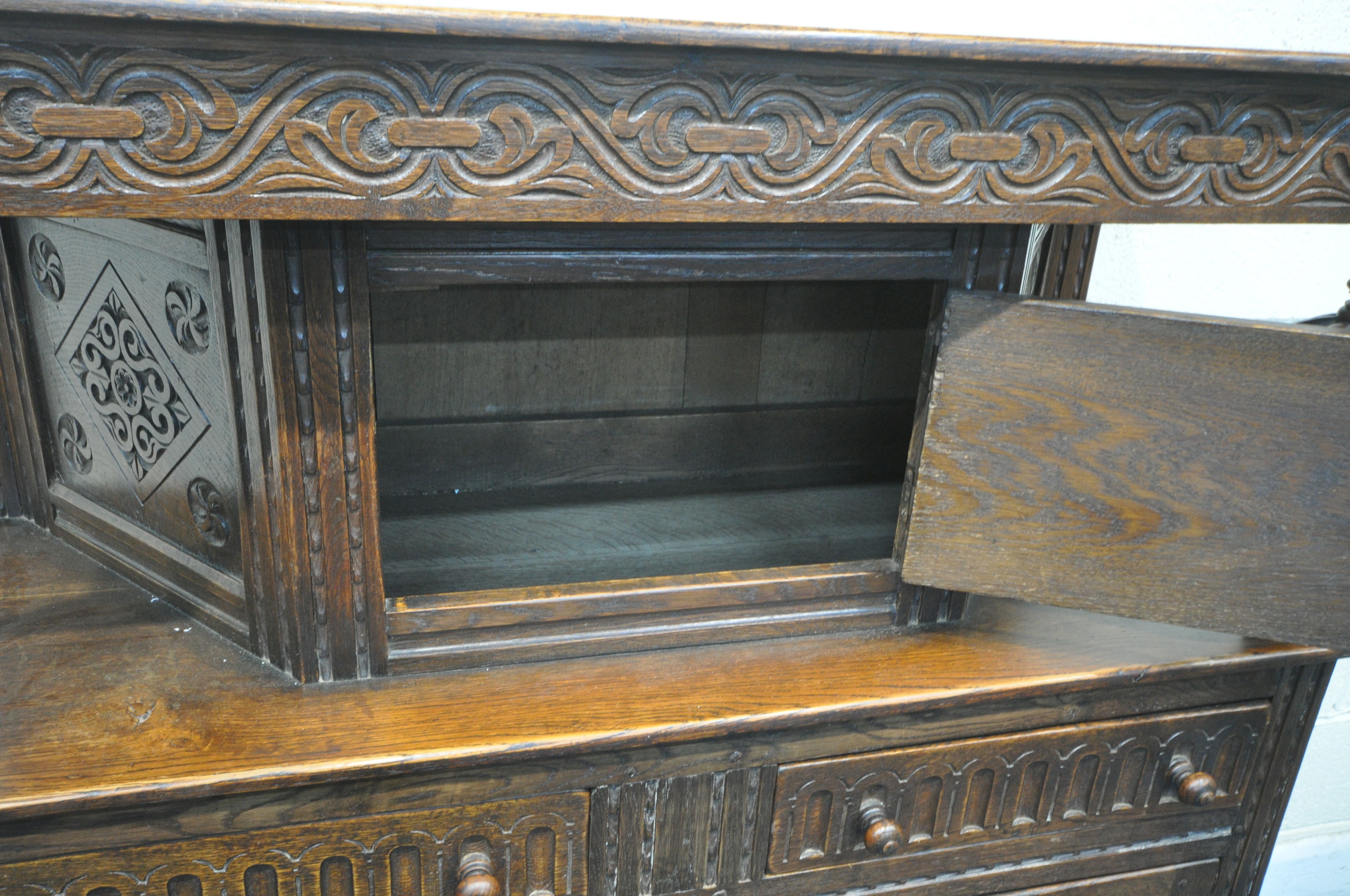 A 20TH CENTURY OAK COURT CUPBOARD, the top with a single cupboard door, scrolled and foliate - Image 5 of 7