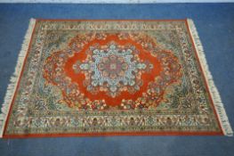 A PRADO RED GROUND WOOLEN RUG, with foliate central medallion and decoration, with multi strap