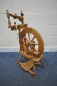 AN ASHFORD BEECH SPINNING WHEEL, with turned supports and spokes (condition report: pedal
