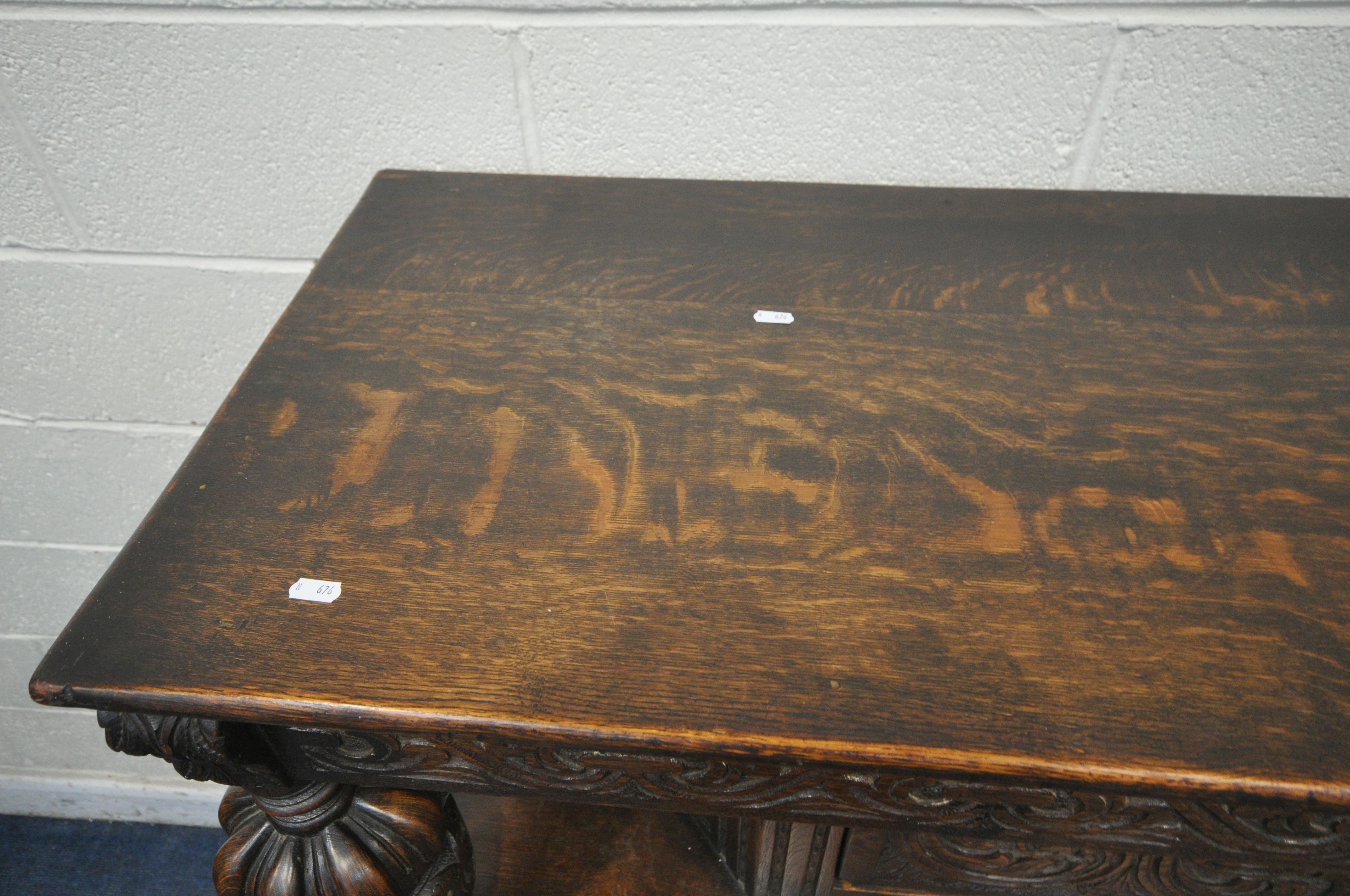 A 20TH CENTURY OAK COURT CUPBOARD, the top with a single cupboard door, scrolled and foliate - Image 2 of 7