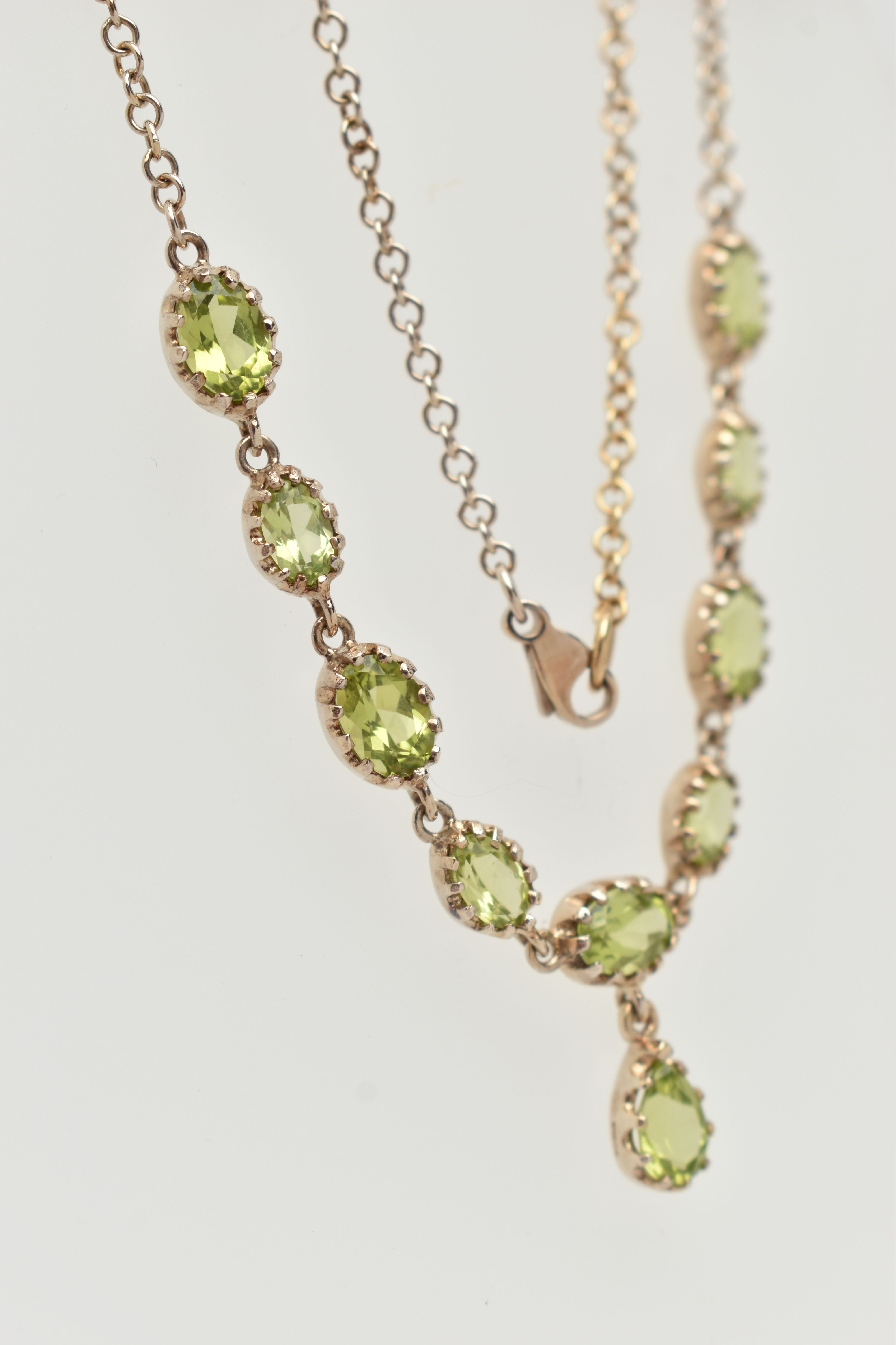 A YELLOW METAL PERIDOT NECKLACE, designed as a row of nine oval cut peridots, each in a claw - Image 3 of 4