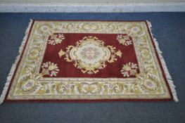 A G H FIRTH WOOLLEN RED, CREAM AND FOLIATE EMPRESS INDIAN RUG, with a central medallion and multi