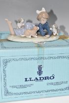 A BOXED LLADRO 'PLAYFUL ROMP' FIGURE, depicting a girl with three puppies, model no 5594, sculptor