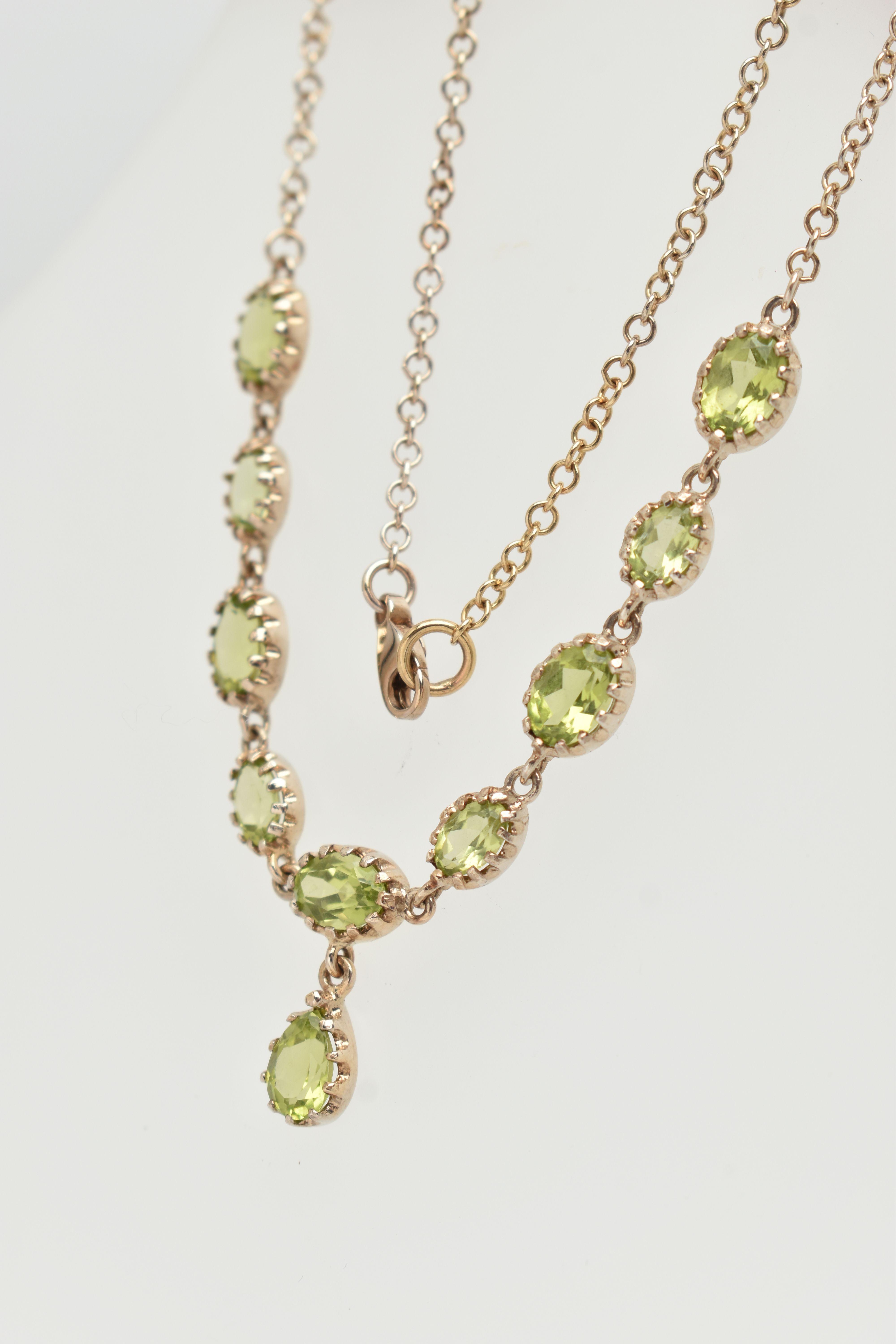 A YELLOW METAL PERIDOT NECKLACE, designed as a row of nine oval cut peridots, each in a claw - Image 4 of 4