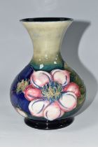 A MOORCROFT POTTERY CLEMATIS VASE, the flared necked vase in 'Clematis' pattern on a graduated green